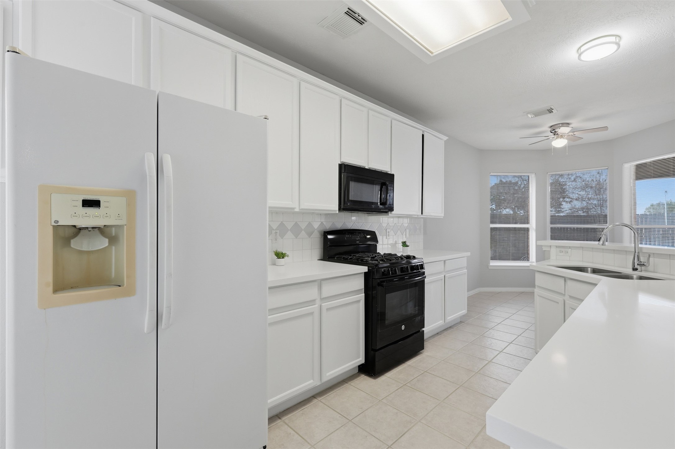 2202 Melanie Park Drive Spring, TX 77388 - Photo 7 of 26 a kitchen with a stove a sink and a refrigerator