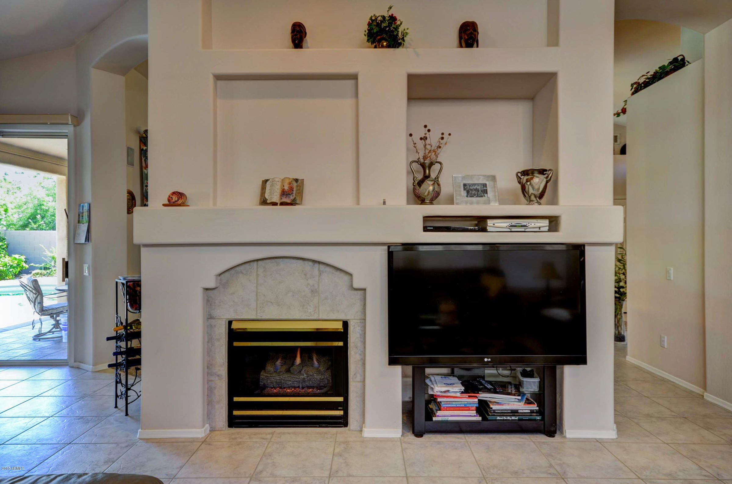 5311 East Danbury Road Scottsdale, AZ 85254 - Photo 12 of 39 a living room with furniture and a fireplace