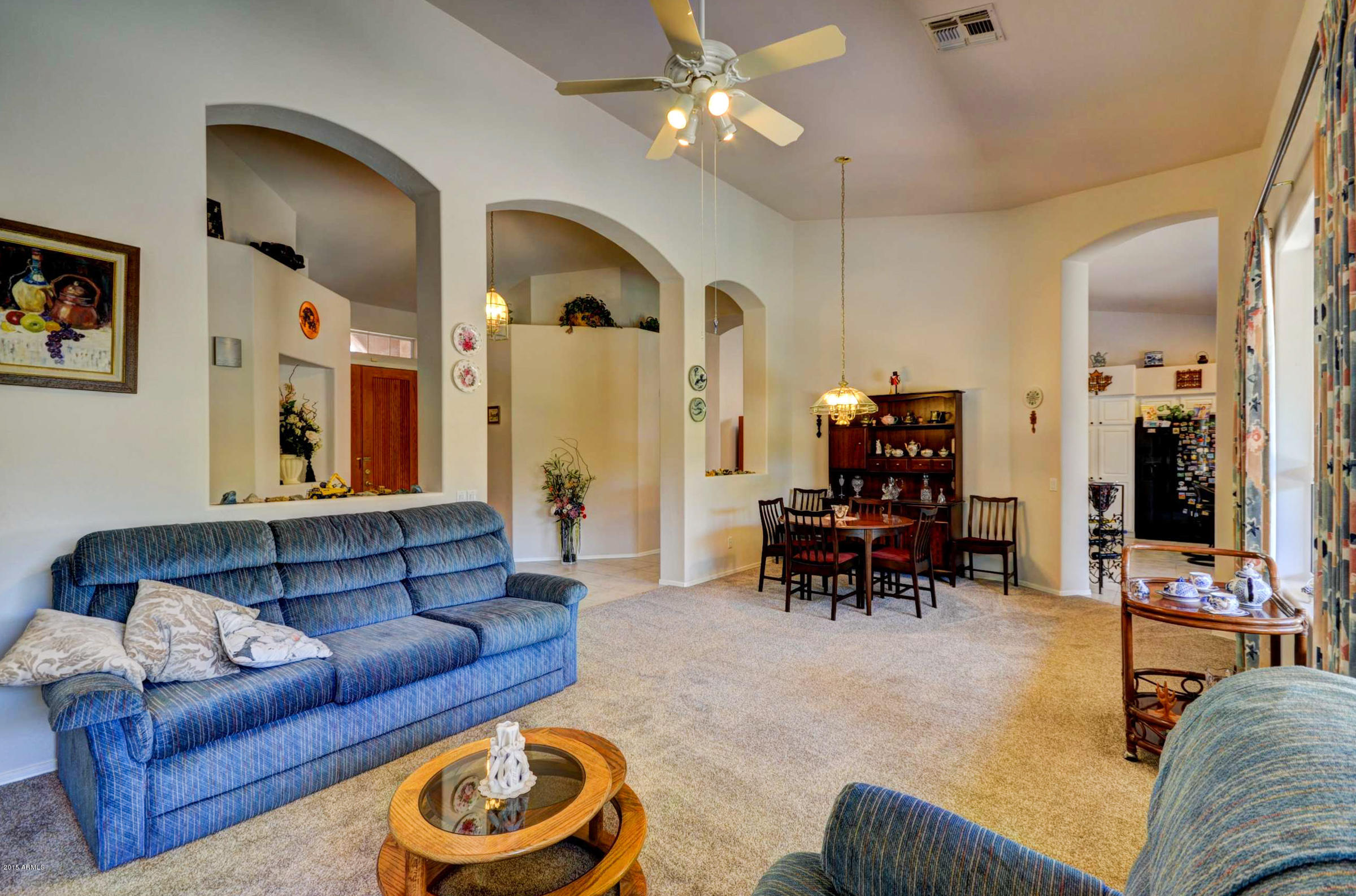 5311 East Danbury Road Scottsdale, AZ 85254 - Photo 15 of 39 a living room with furniture and a chandelier