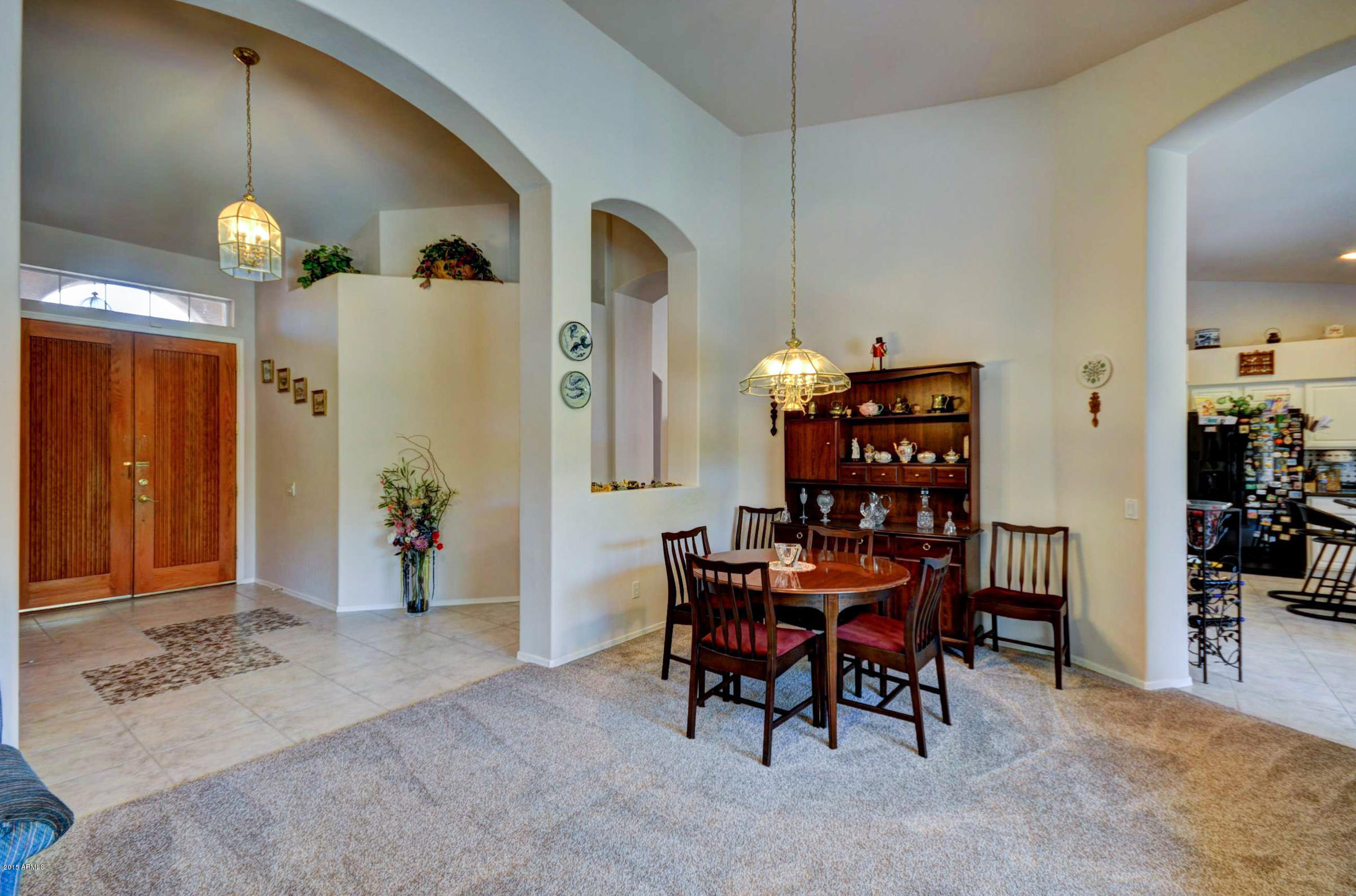 5311 East Danbury Road Scottsdale, AZ 85254 - Photo 16 of 39 a view of a dining room with furniture and chandelier