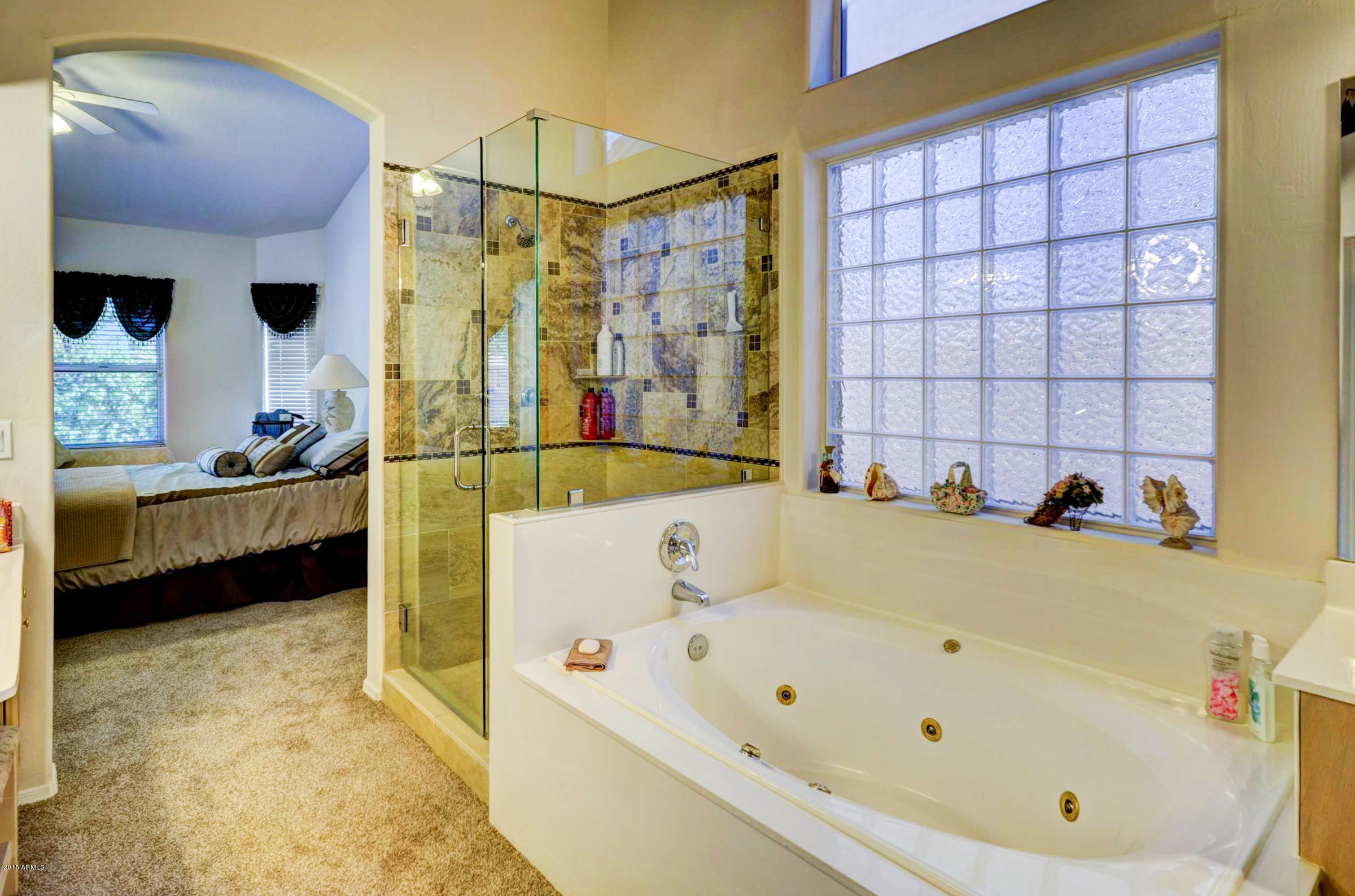 5311 East Danbury Road Scottsdale, AZ 85254 - Photo 24 of 39 a bathroom with a tub a sink and a shower
