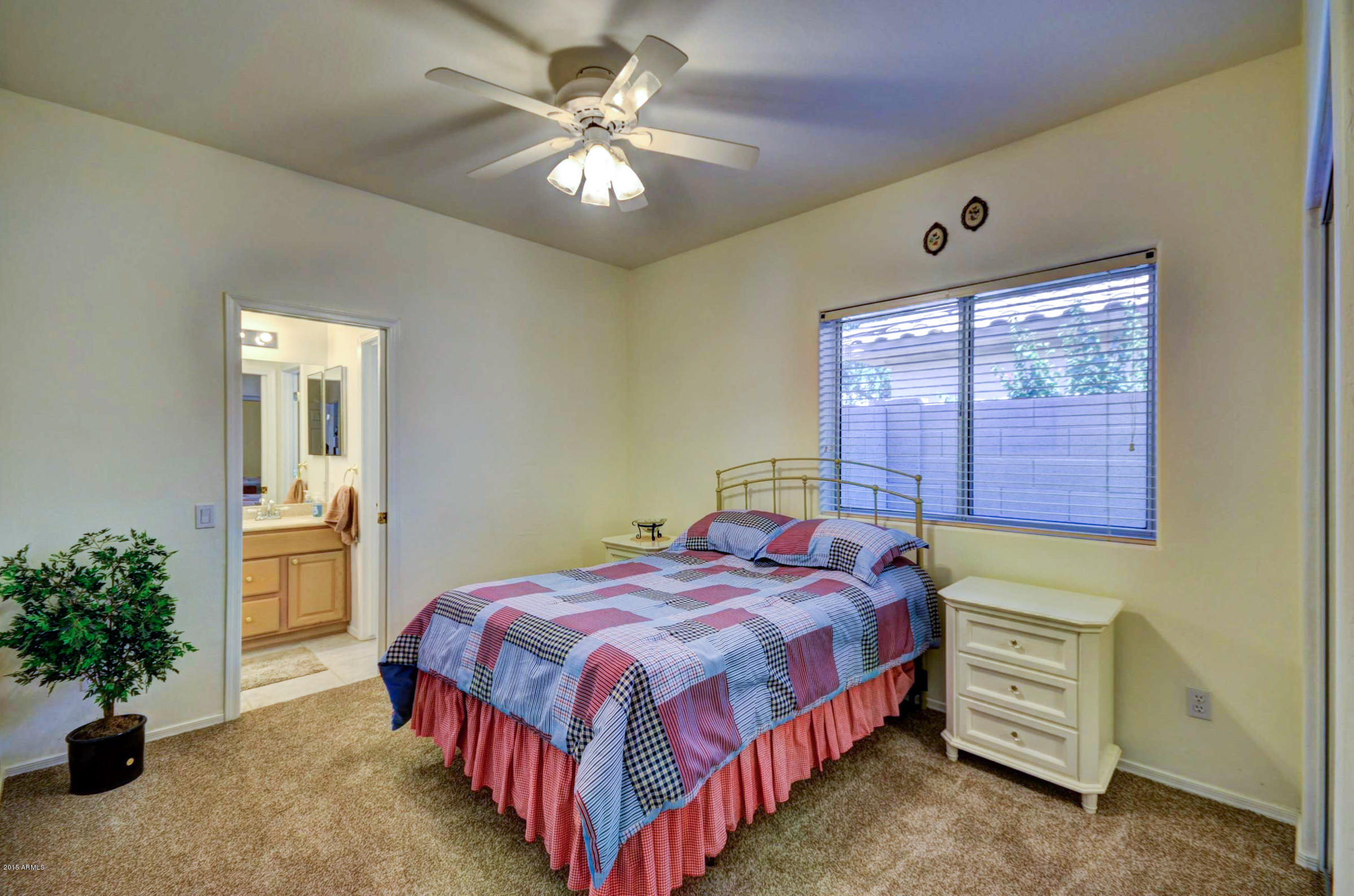 5311 East Danbury Road Scottsdale, AZ 85254 - Photo 25 of 39 a bedroom with a bed and a chandelier