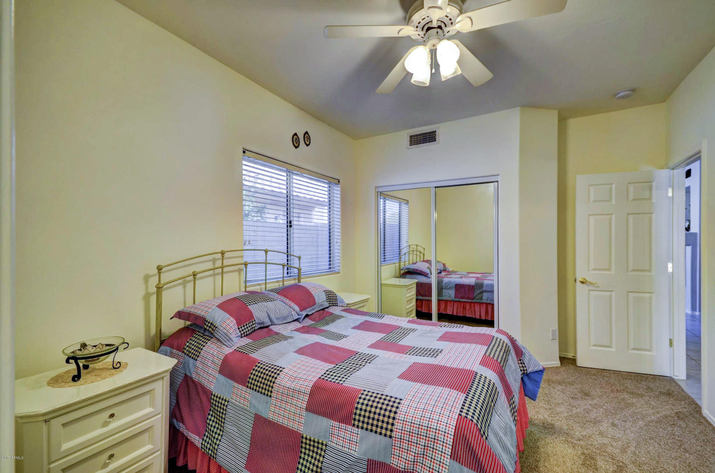 5311 East Danbury Road Scottsdale, AZ 85254 - Photo 26 of 39 a bedroom with a bed and a chandelier