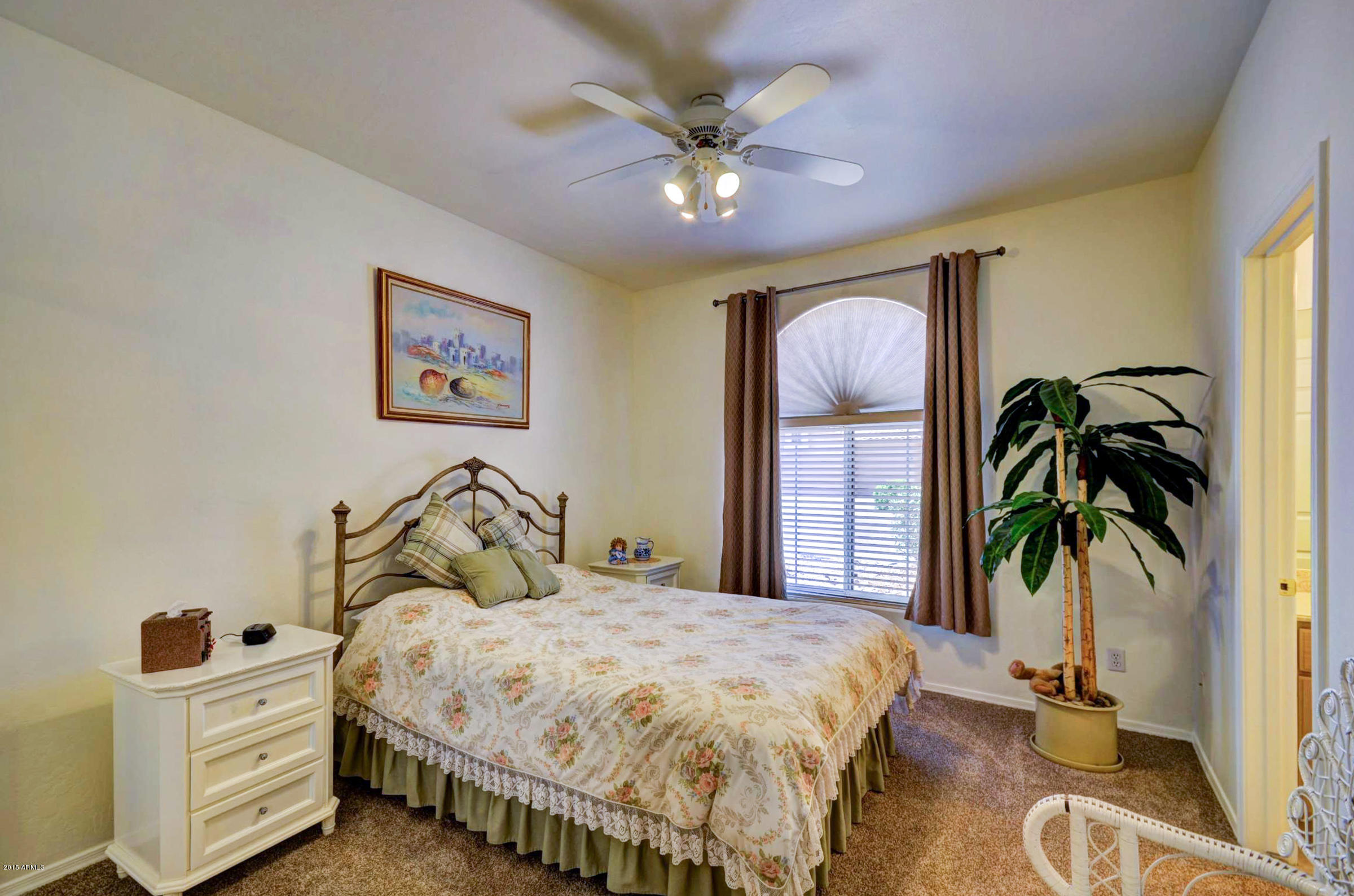 5311 East Danbury Road Scottsdale, AZ 85254 - Photo 27 of 39 a bedroom with a bed and a potted plant