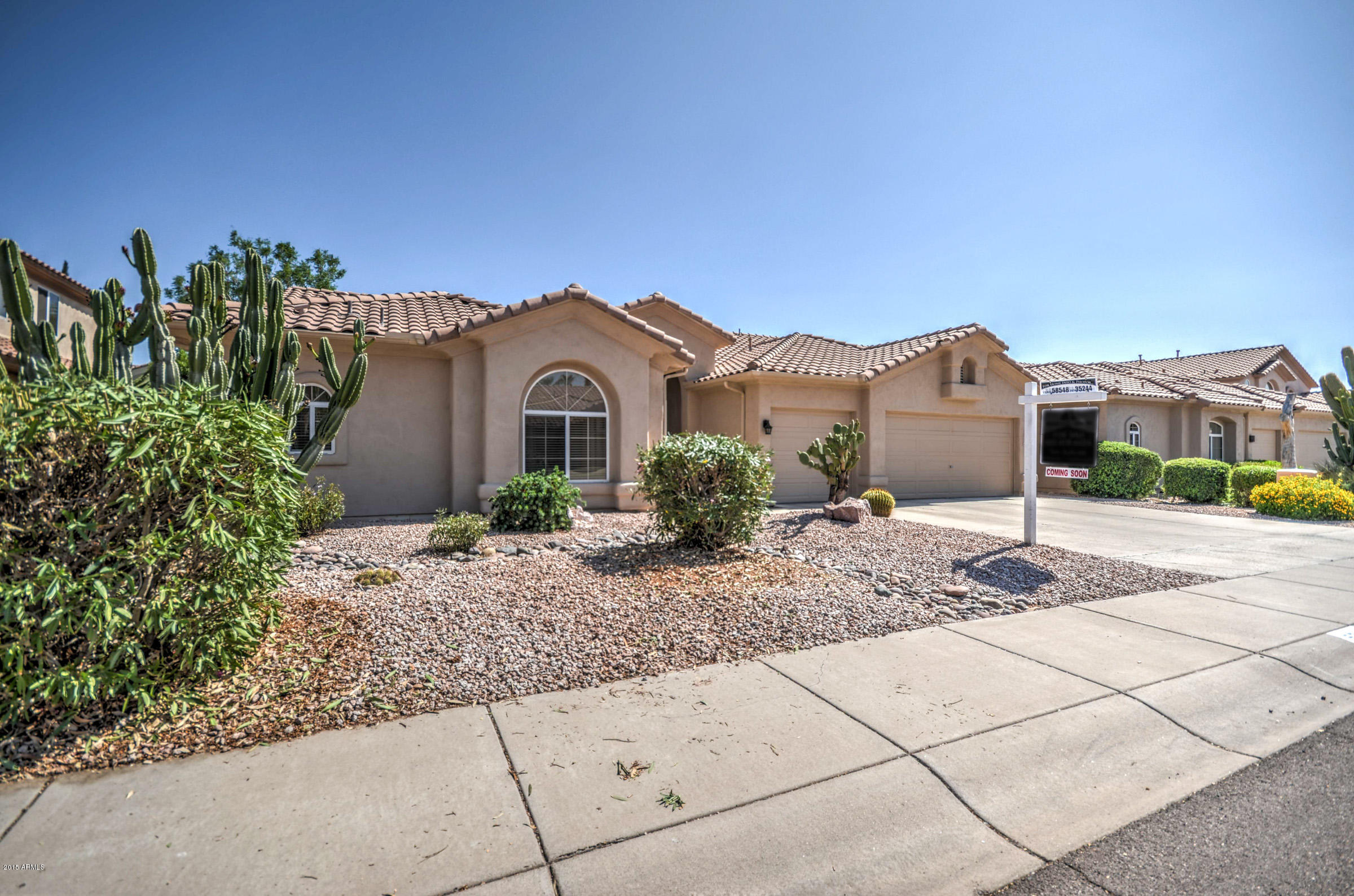 5311 East Danbury Road Scottsdale, AZ 85254 - Photo 3 of 39 a front view of a house with a garden
