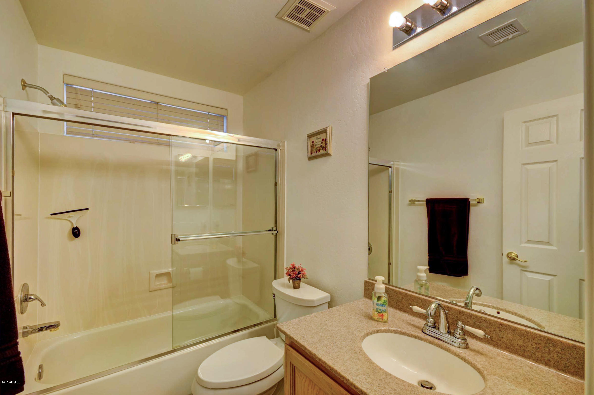 5311 East Danbury Road Scottsdale, AZ 85254 - Photo 31 of 39 a bathroom with a sink toilet and shower
