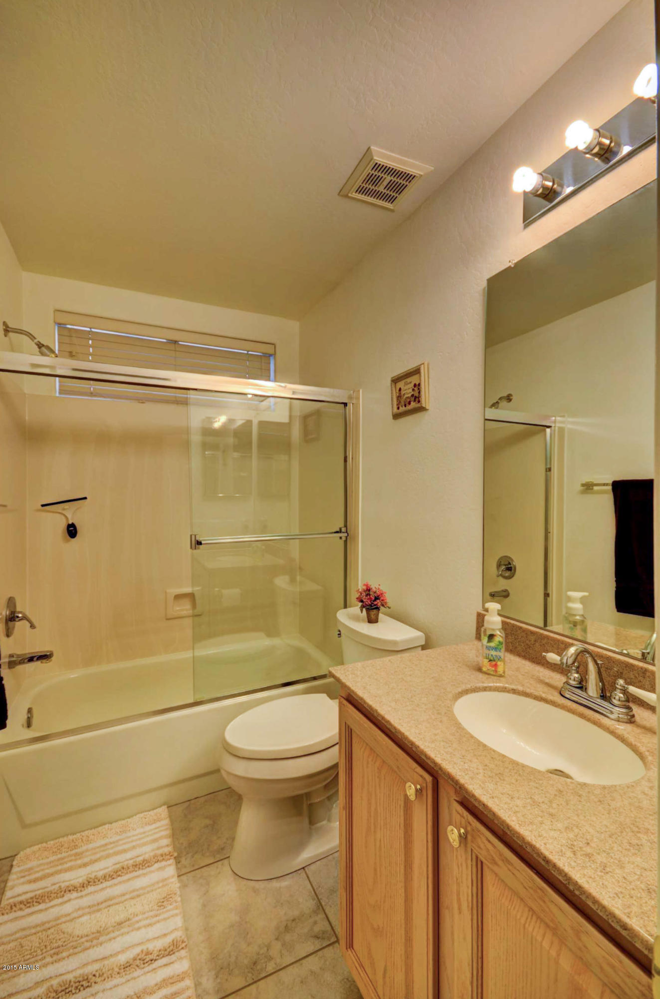 5311 East Danbury Road Scottsdale, AZ 85254 - Photo 32 of 39 a bathroom with a granite countertop sink toilet and shower