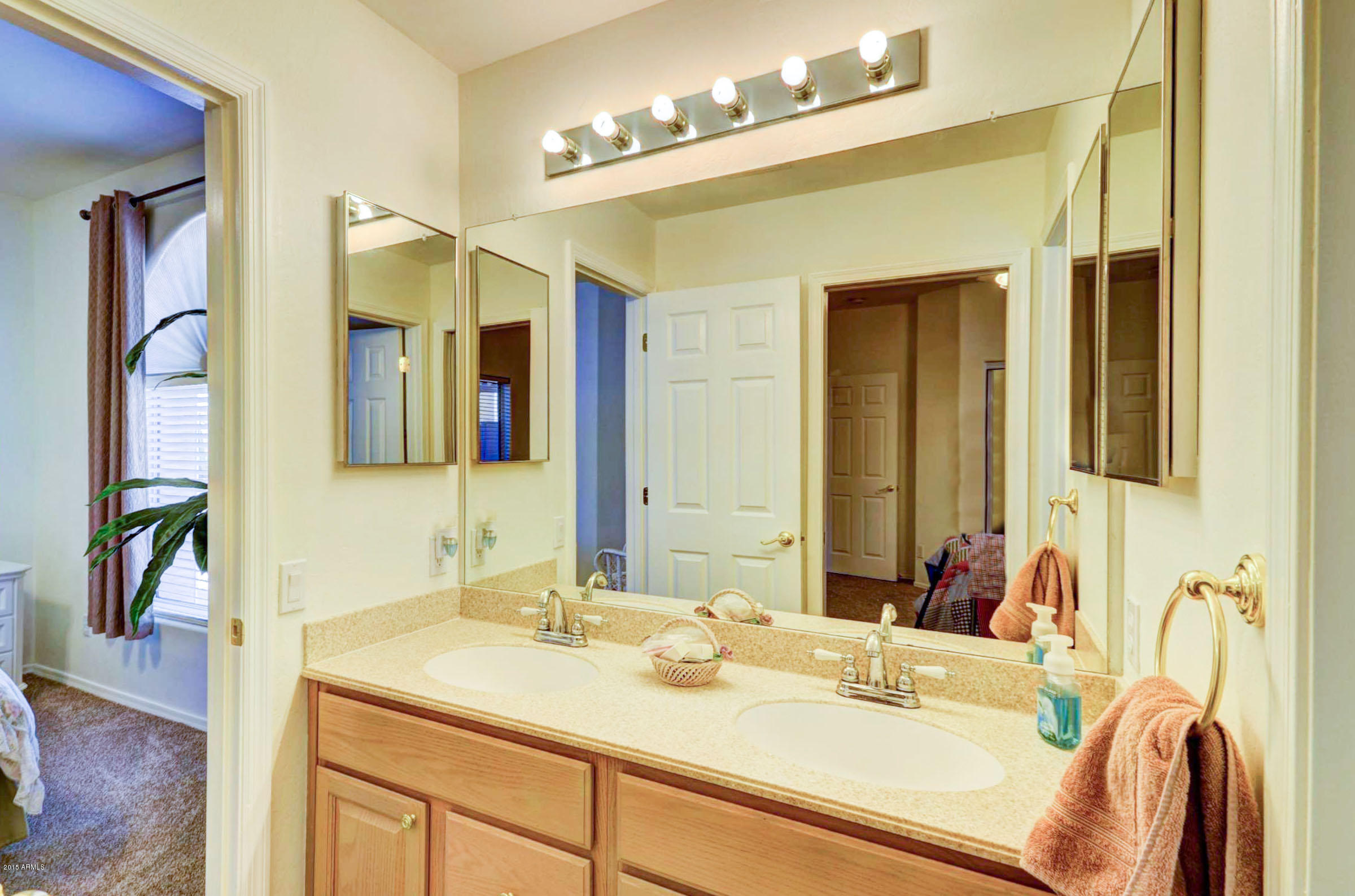 5311 East Danbury Road Scottsdale, AZ 85254 - Photo 33 of 39 a bathroom with a granite countertop sink and a mirror