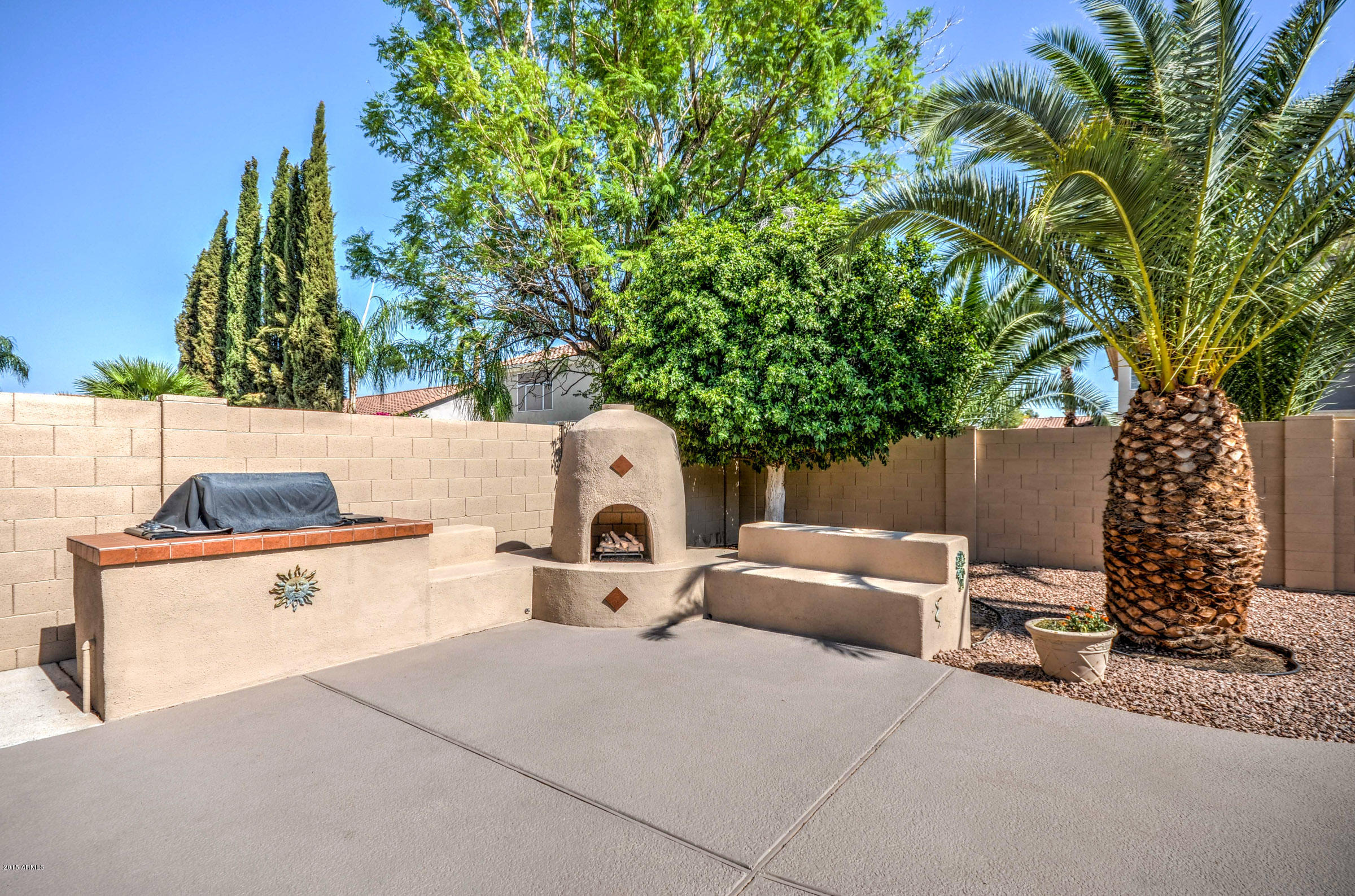 5311 East Danbury Road Scottsdale, AZ 85254 - Photo 35 of 39 a view of a patio with table and chairs with a large tree