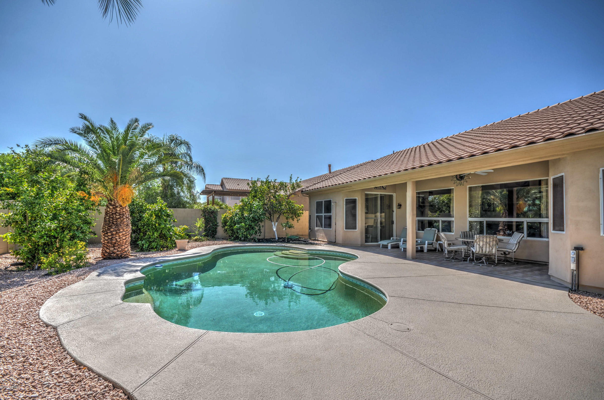 5311 East Danbury Road Scottsdale, AZ 85254 - Photo 36 of 39 a view of a house with swimming pool and sitting area