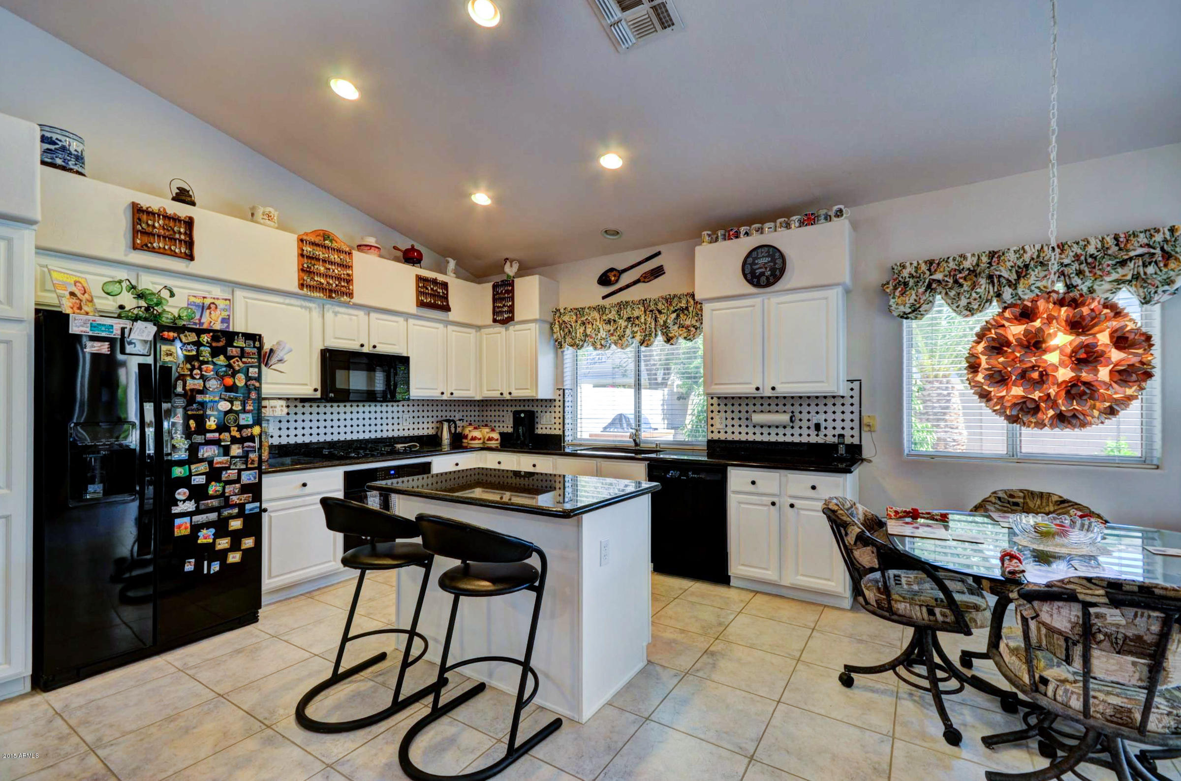 5311 East Danbury Road Scottsdale, AZ 85254 - Photo 5 of 39 a kitchen with stainless steel appliances granite countertop a stove a sink dishwasher and a refrigerator with wooden floor