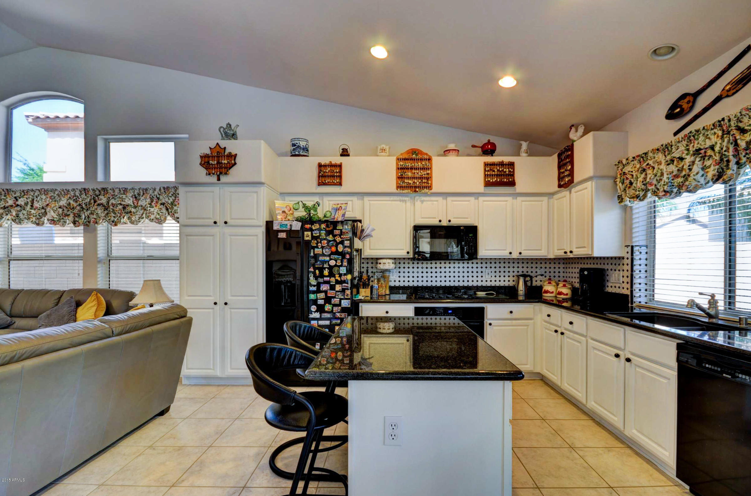 5311 East Danbury Road Scottsdale, AZ 85254 - Photo 7 of 39 a kitchen with stainless steel appliances granite countertop a sink a stove and a refrigerator