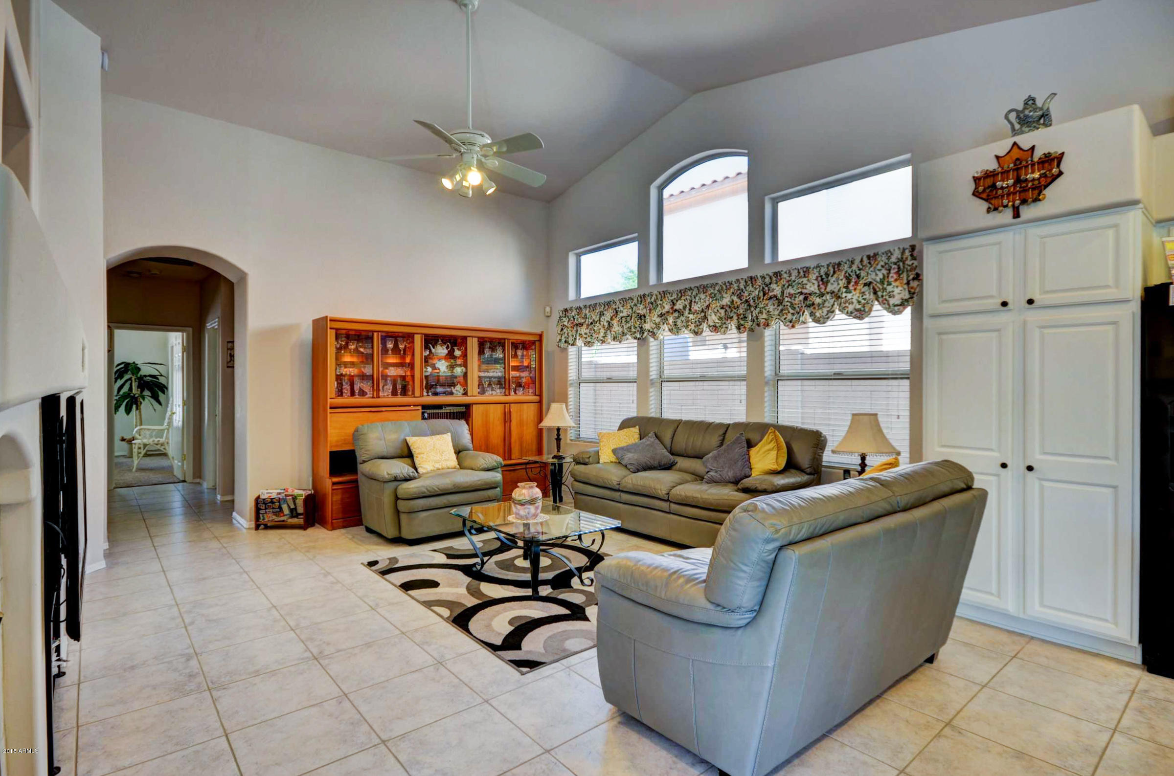5311 East Danbury Road Scottsdale, AZ 85254 - Photo 9 of 39 a living room with furniture and a chandelier