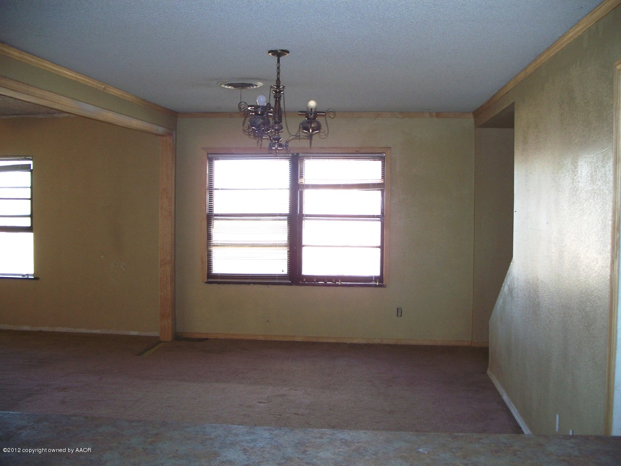 1115 West McCormick Road Amarillo, TX 79118 - Photo 4 of 15 an empty room with chandelier fan and windows