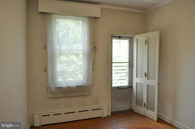 3909 Keswick Road Baltimore, MD 21211 - Photo 15 of 23 a view of an empty room with wooden floor and a window