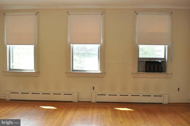 3909 Keswick Road Baltimore, MD 21211 - Photo 17 of 23 a view of a room with wooden floor and a window
