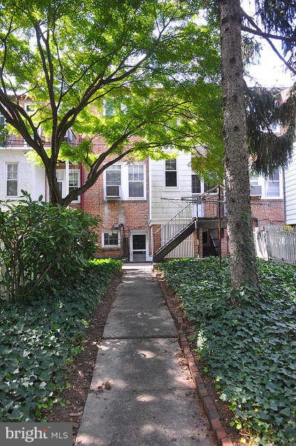 3909 Keswick Road Baltimore, MD 21211 - Photo 21 of 23 a front view of a house with a yard and large trees