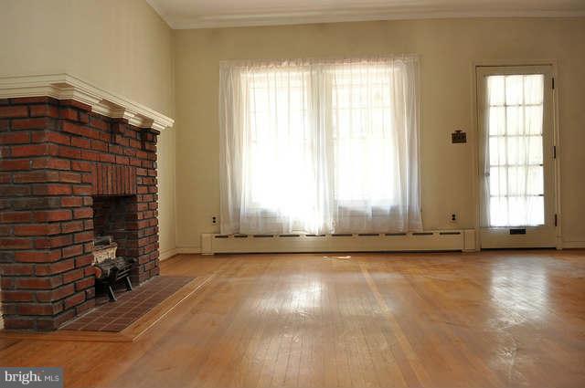 3909 Keswick Road Baltimore, MD 21211 - Photo 7 of 23 an empty room with wooden floor and windows