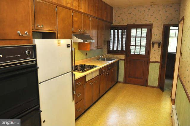 3909 Keswick Road Baltimore, MD 21211 - Photo 8 of 23 a kitchen with stainless steel appliances granite countertop a refrigerator a stove and a sink