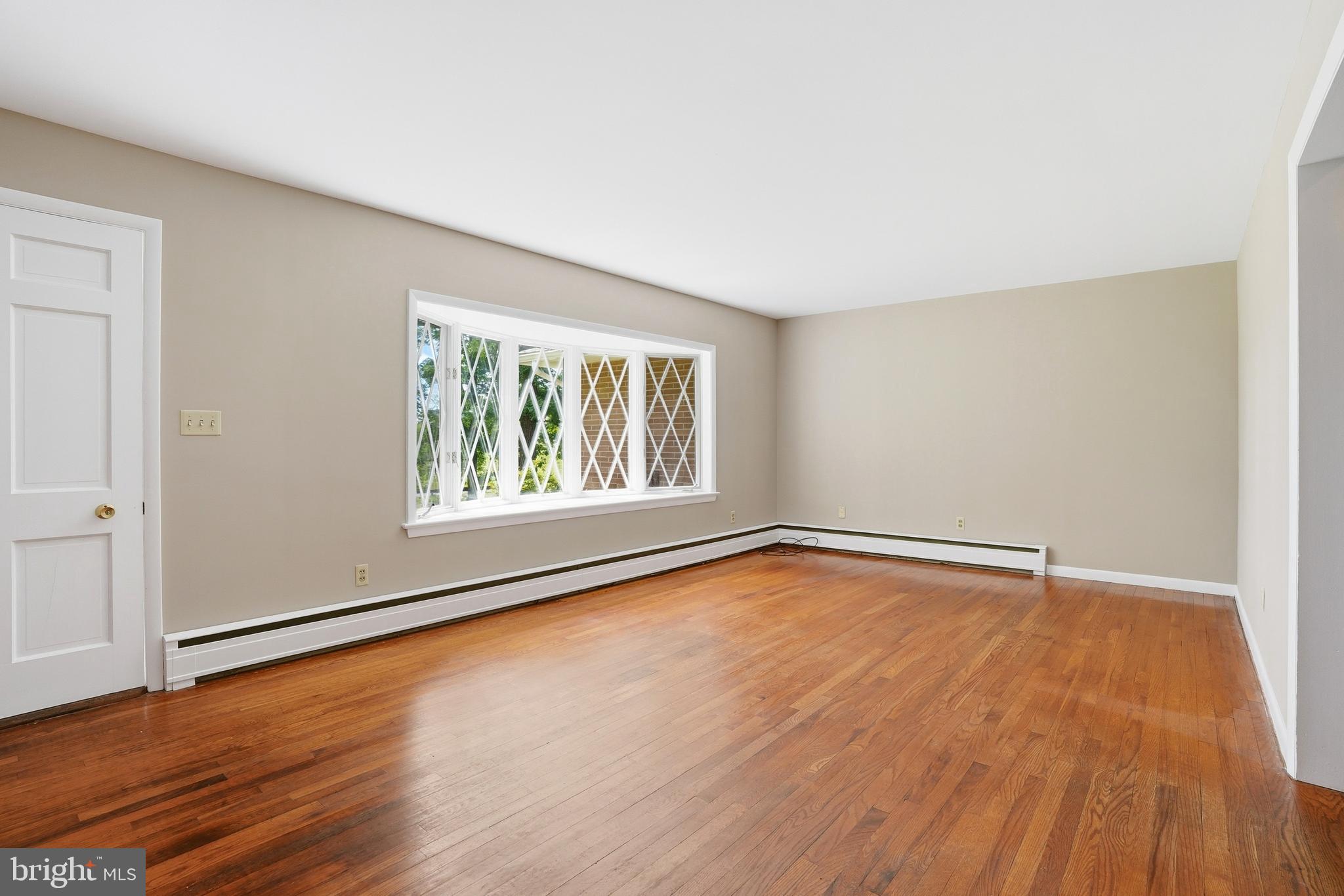 486 Derstine Road Hatfield, PA 19440 - Photo 6 of 53 a view of an empty room with wooden floor and a window