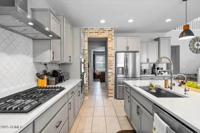 a large kitchen with kitchen island a large counter top