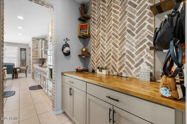 a living room with stainless steel appliances kitchen island granite countertop furniture and a view of kitchen