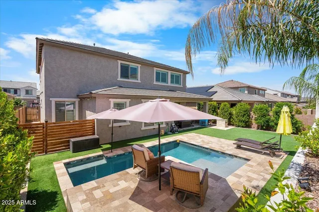a view of a patio with table and chairs