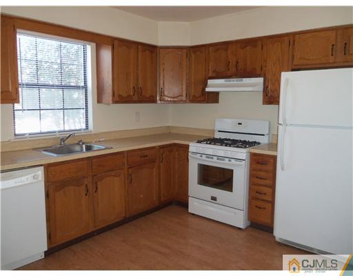 1904 Timber Oaks Road Edison, NJ 08820 - Photo 2 of 6 a kitchen with granite countertop white cabinets and white appliances