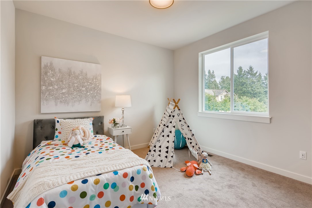3821 208th Place Southeast Bothell, WA 98021 - Photo 22 of 28 a bedroom with a bed and a window