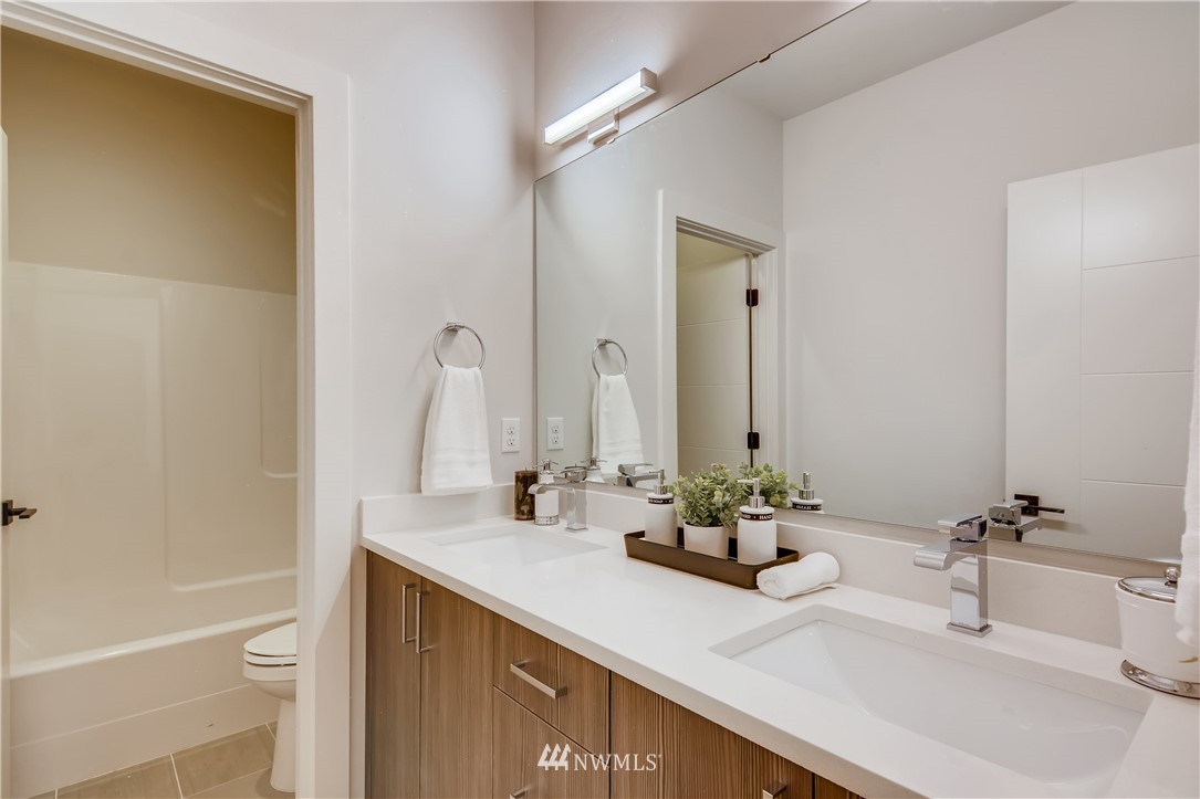 3821 208th Place Southeast Bothell, WA 98021 - Photo 25 of 28 a bathroom with double sink and a mirror