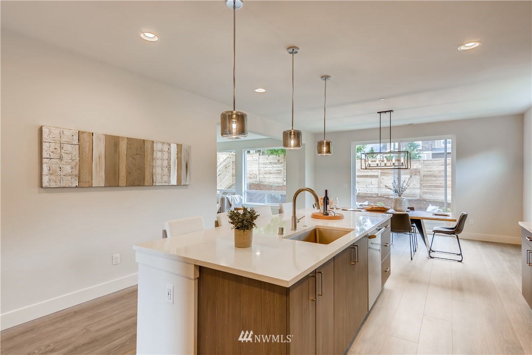 3821 208th Place Southeast Bothell, WA 98021 - Photo 10 of 28 a kitchen with a sink a counter and chairs
