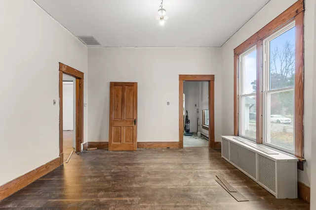 a view of a livingroom with wooden floor and a window