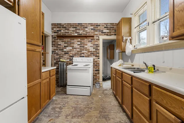 a kitchen with a refrigerator and a stove