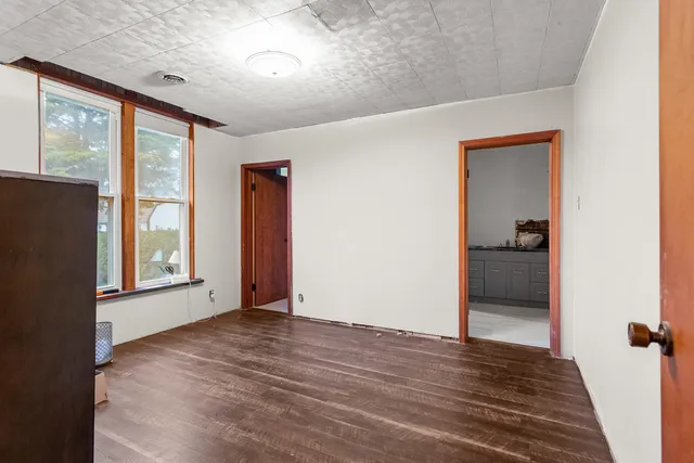 an empty room with furniture and wooden floor