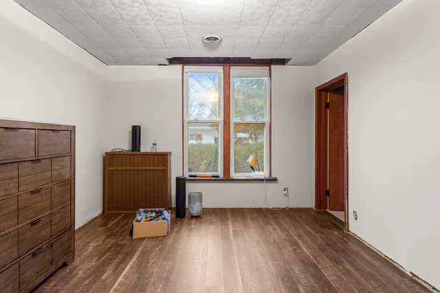 a bathroom with a granite countertop toilet and a sink