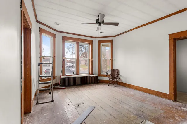 a view of a room with wooden floor and potted plant