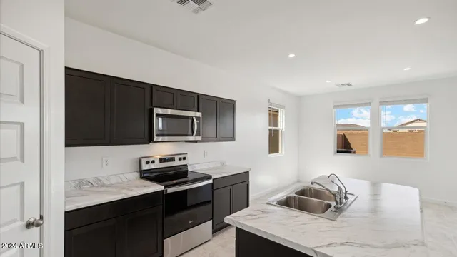 a kitchen with a stove and a refrigerator