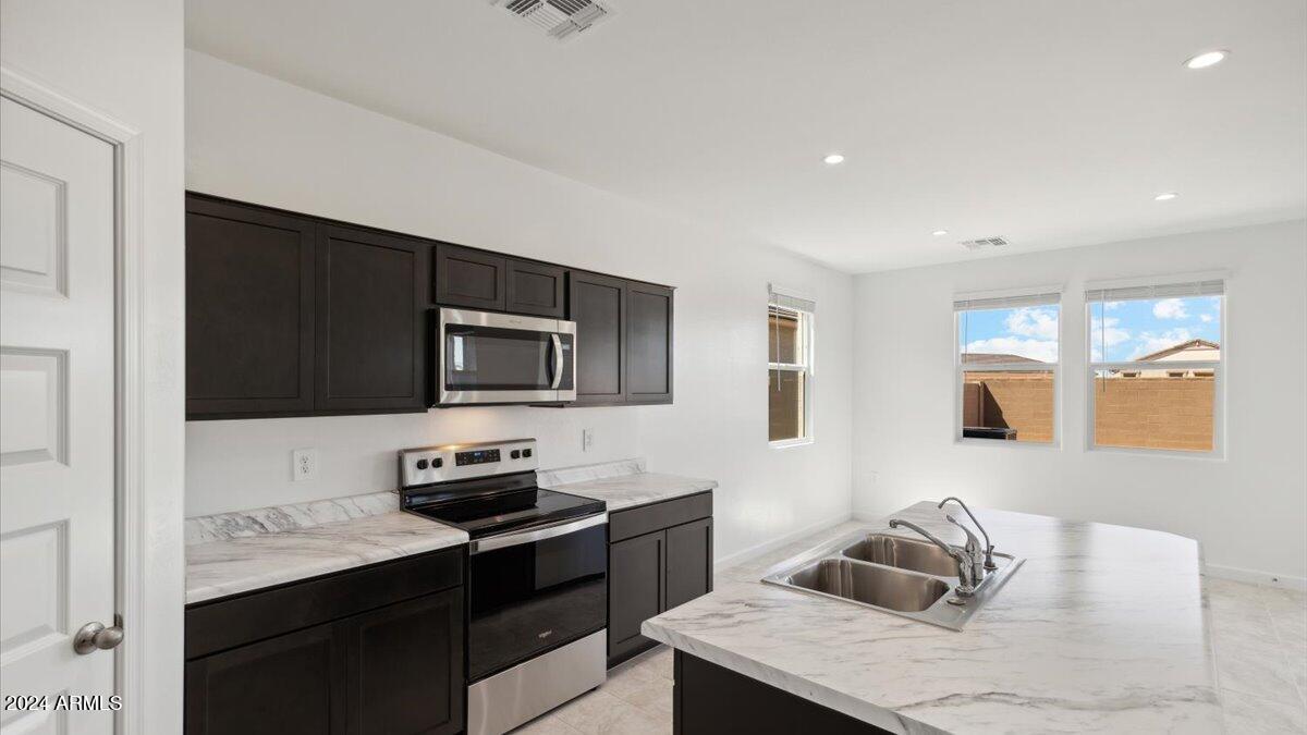 9202 South Palo Verde Drive Apache Junction, AZ 85120 - Photo 11 of 24 a kitchen with a stove and a refrigerator