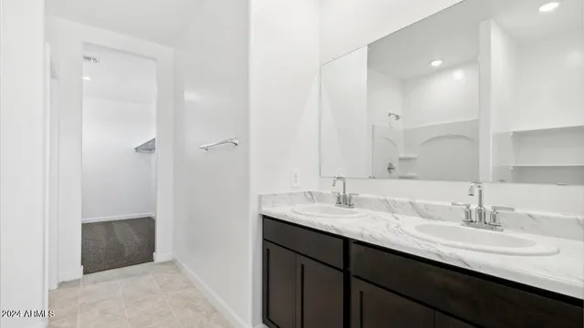 a bathroom with a double vanity sink and mirror