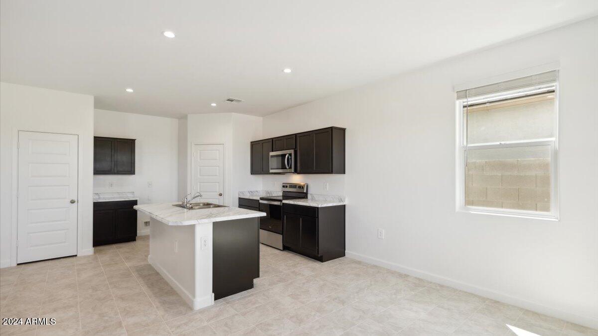 9202 South Palo Verde Drive Apache Junction, AZ 85120 - Photo 8 of 24 a view of kitchen with stainless steel appliances kitchen island sink stove and refrigerator