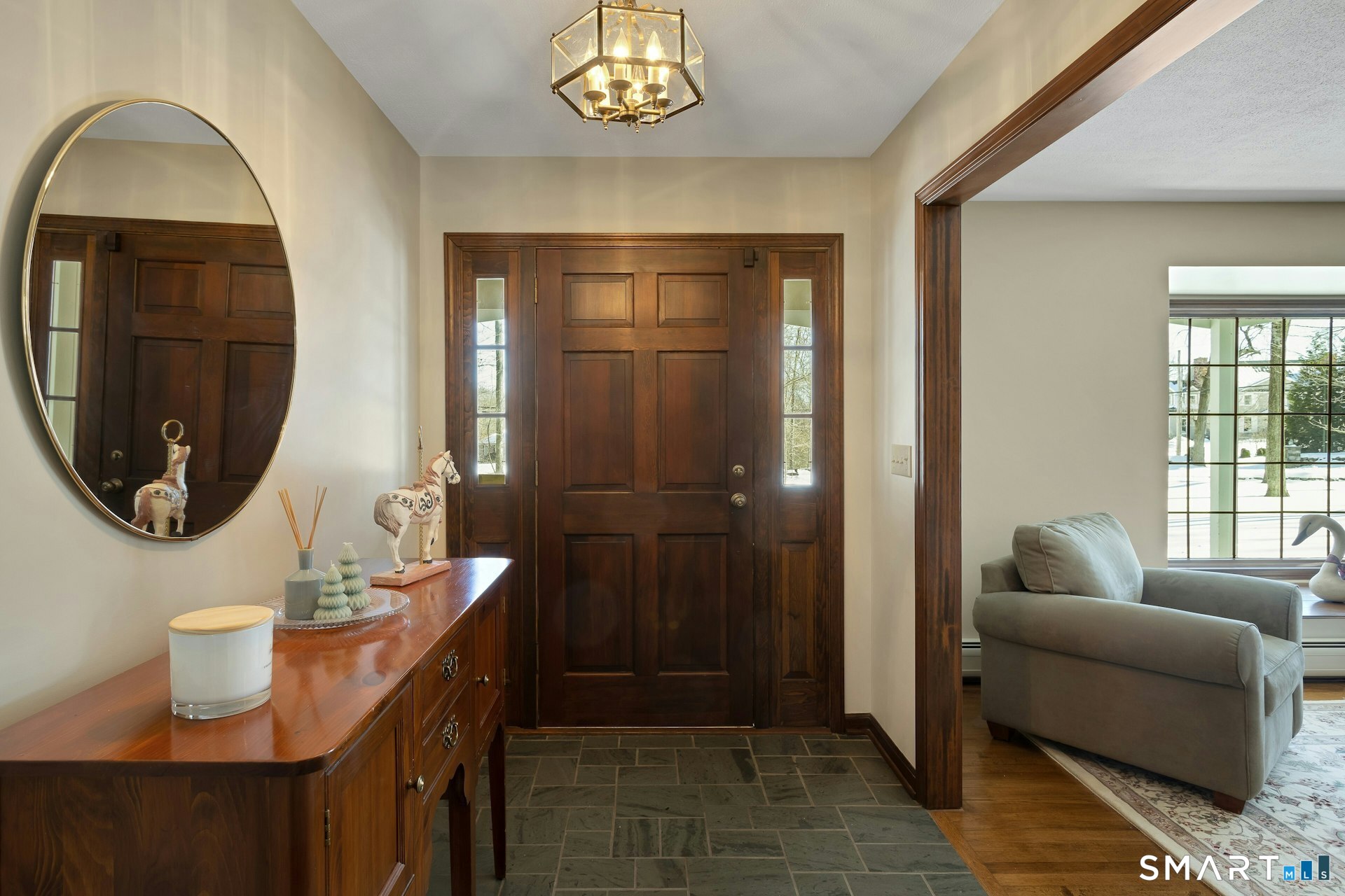295 Judd Road Easton, CT 06612 - Photo 17 of 33 a living room with furniture a mirror and a window