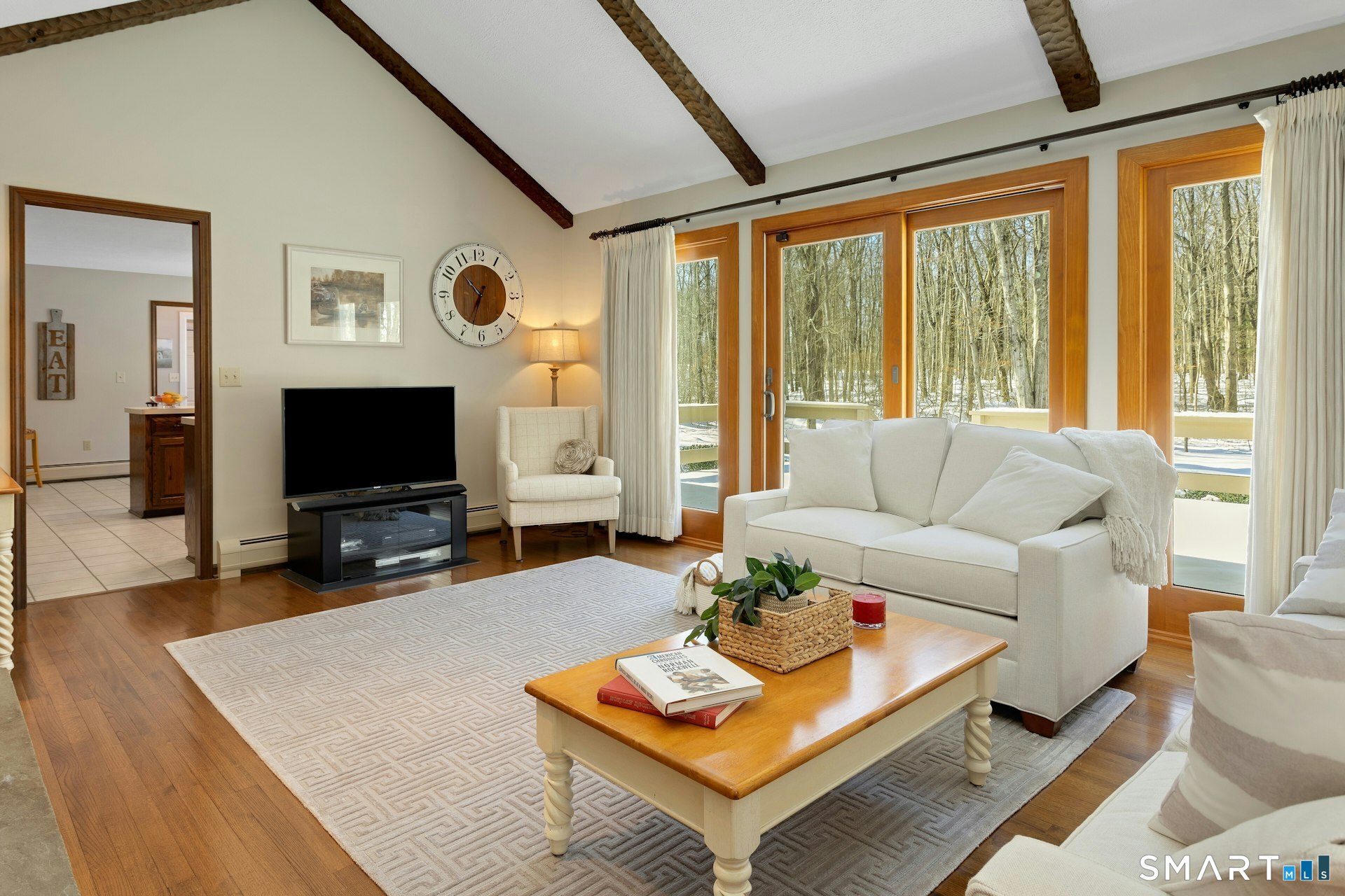 295 Judd Road Easton, CT 06612 - Photo 25 of 33 a living room with furniture a flat screen tv and a large window