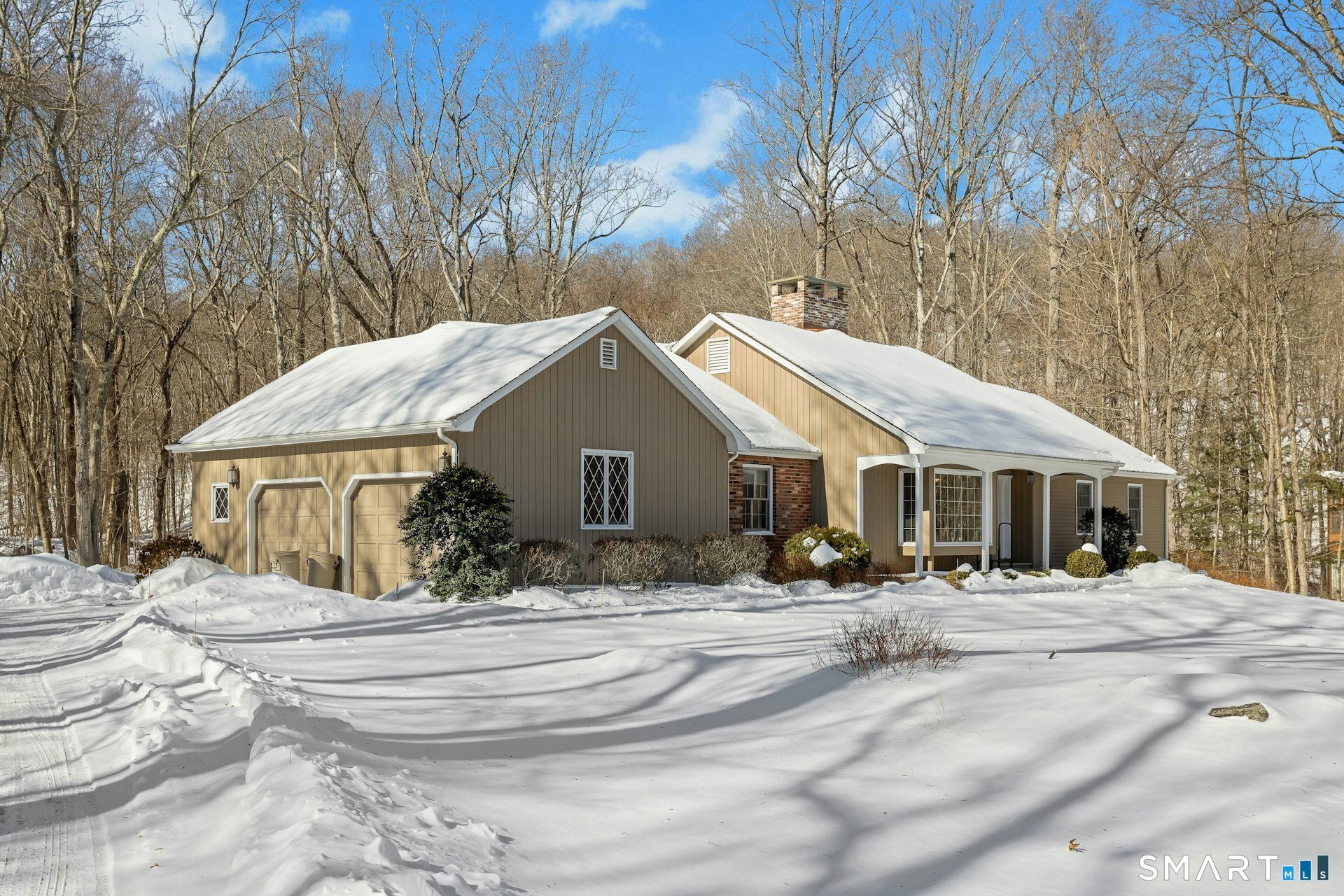 295 Judd Road Easton, CT 06612 - Photo 33 of 33 a front view of a house with a yard covered with snow