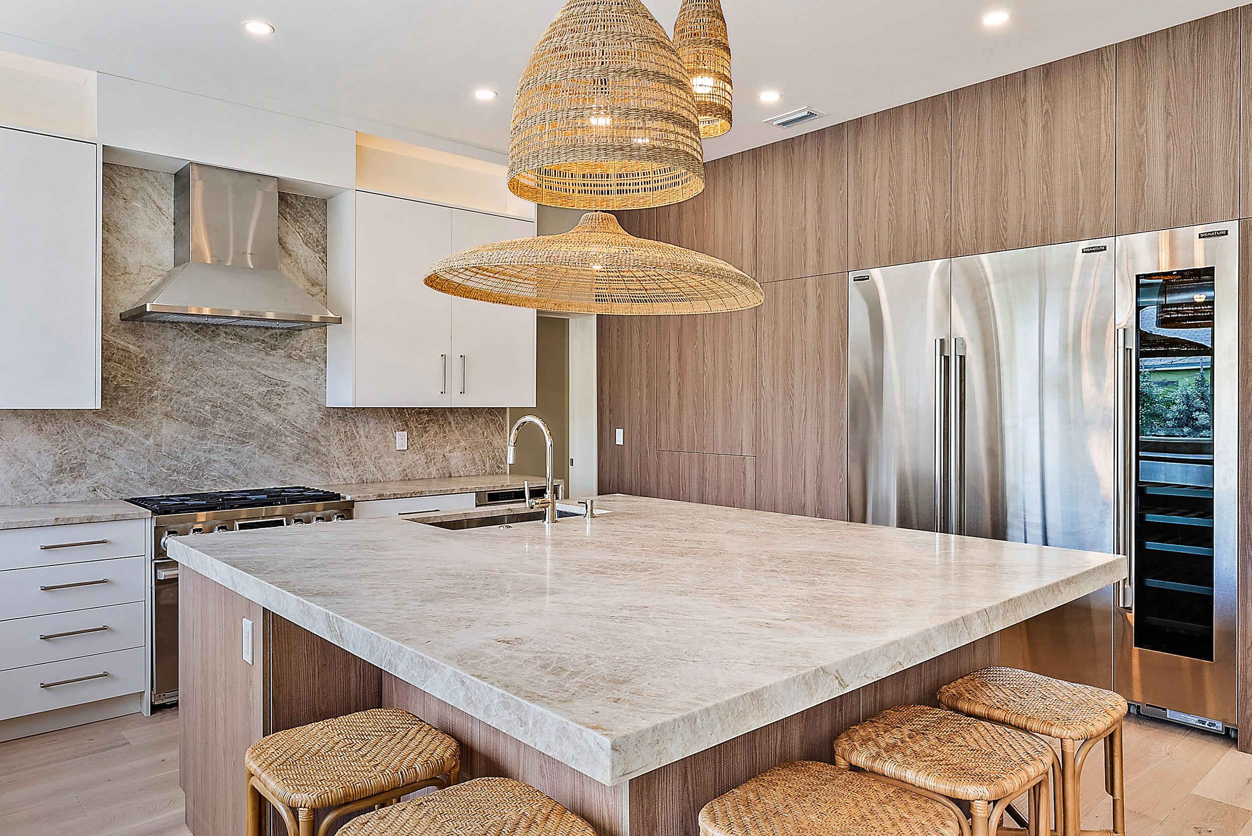 310 Edmor Road West Palm Beach, FL 33405 - Photo 11 of 32 a kitchen with stainless steel appliances a table chairs and a refrigerator