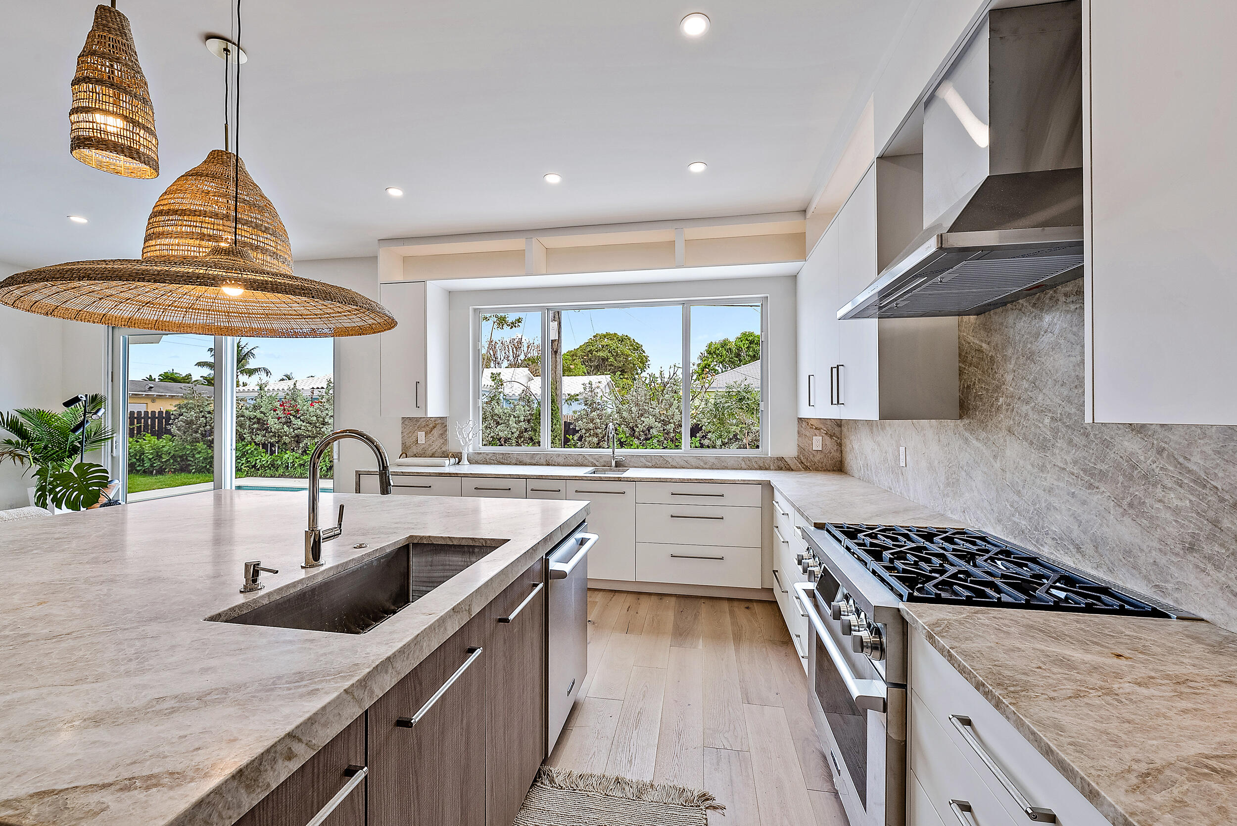 310 Edmor Road West Palm Beach, FL 33405 - Photo 14 of 32 a kitchen with stainless steel appliances granite countertop a sink a counter space and a view of living room