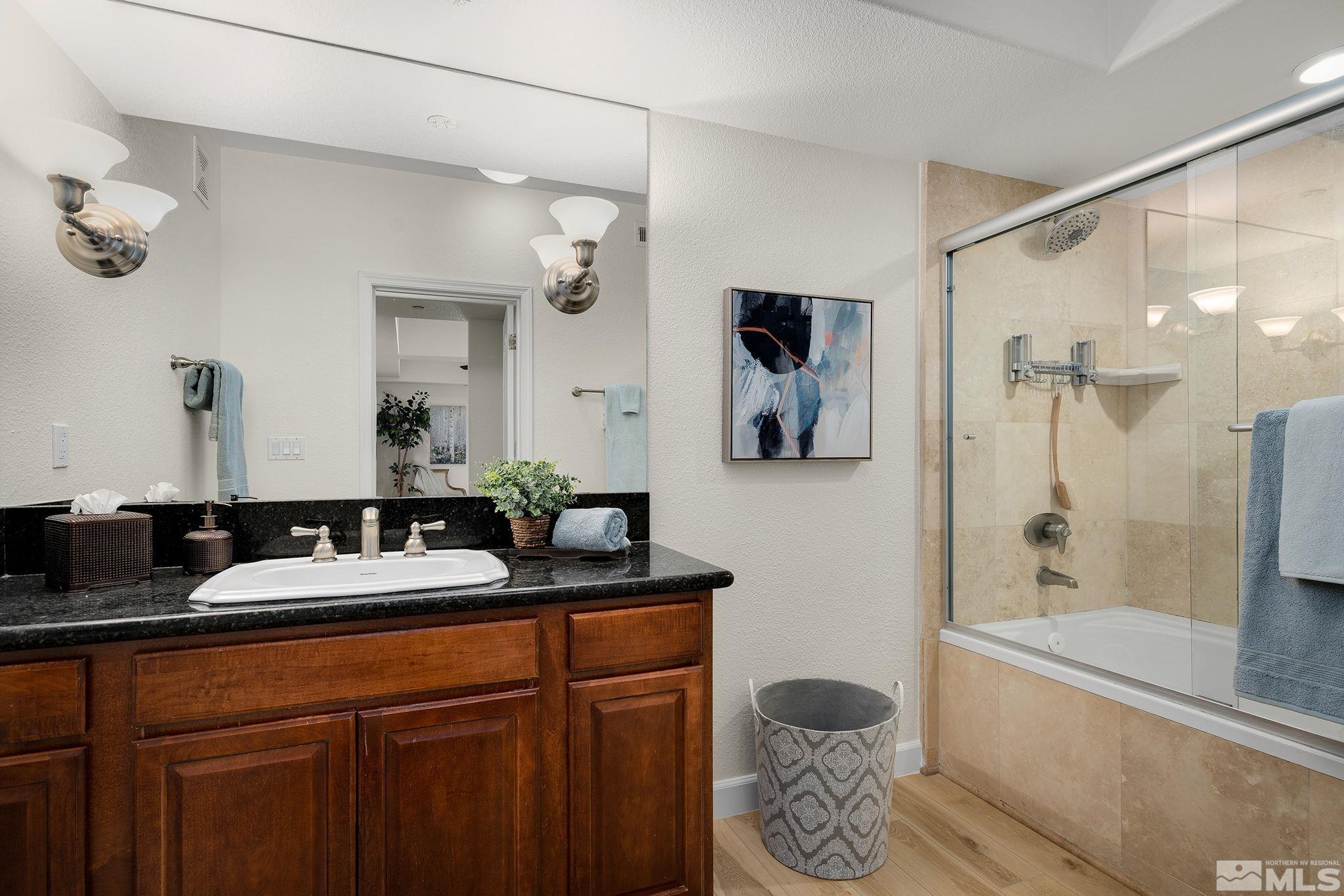 200 West 2nd Street, Unit 1503 Reno, NV 89501 - Photo 10 of 28 a bathroom with a double vanity sink mirror and shower