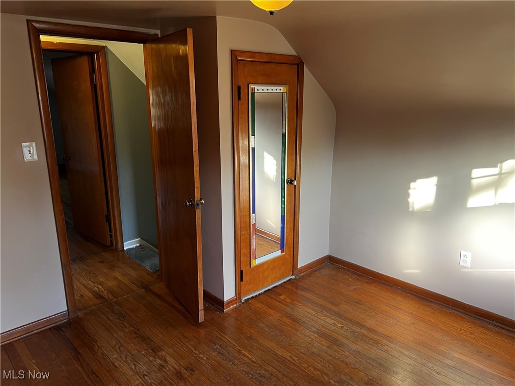 912 Middlebury Road Kent, OH 44240 - Photo 3 of 5 Bonus room featuring dark wood-style flooring, baseboards, and lofted ceiling