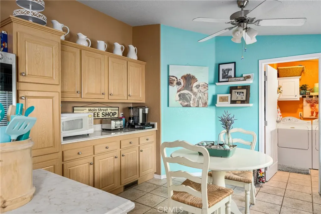 1051 Site, Unit 91 Brea, CA 92821 - Photo 22 of 32 a kitchen with stainless steel appliances kitchen island granite countertop a refrigerator a stove a sink dishwasher and white countertops with wooden floor