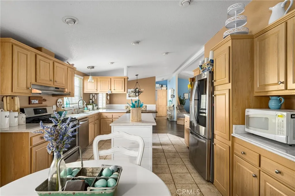 1051 Site, Unit 91 Brea, CA 92821 - Photo 23 of 32 a kitchen with stainless steel appliances granite countertop a refrigerator sink and cabinets