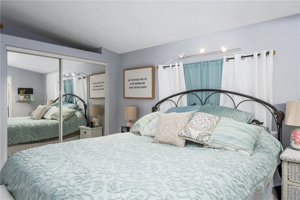1051 Site, Unit 91 Brea, CA 92821 - Photo 26 of 32 a bedroom with a bed and a mirror